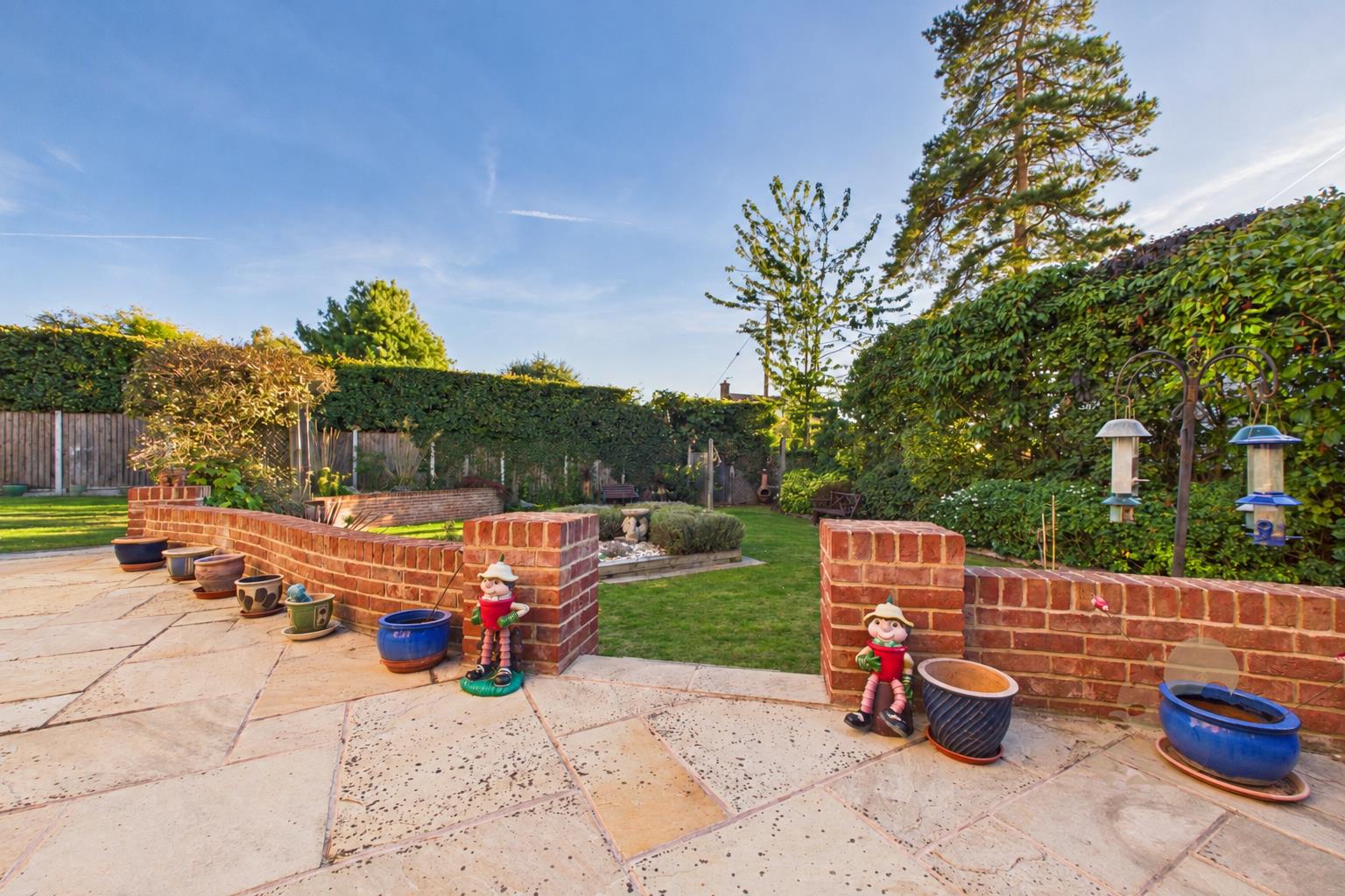 Sunny Backyard Garden with Vibrant Lawn.png